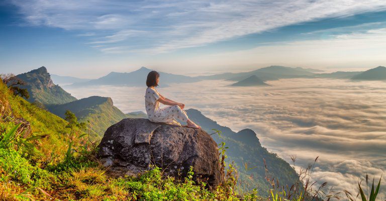 About Conscious Living - woman watching foggy valley